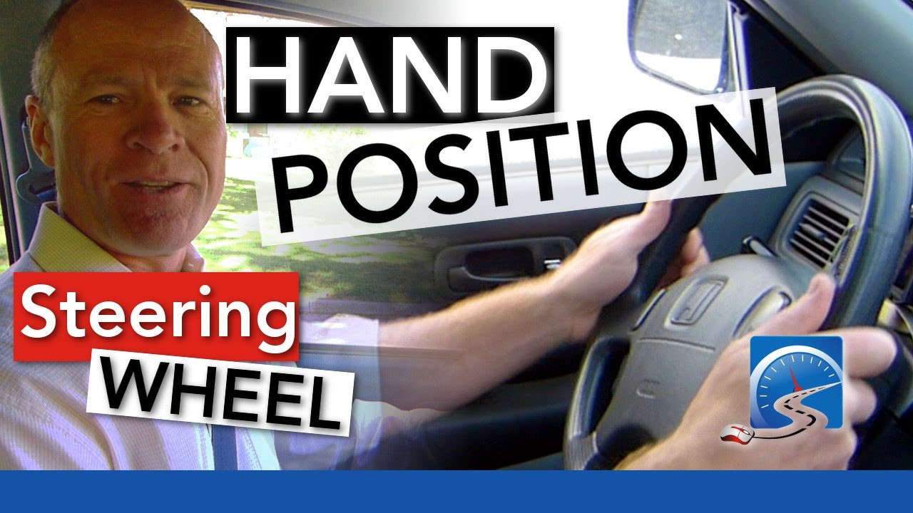 Driving instructor at Get Drivers Ed demonstrating proper hand placement on the steering wheel to a student.