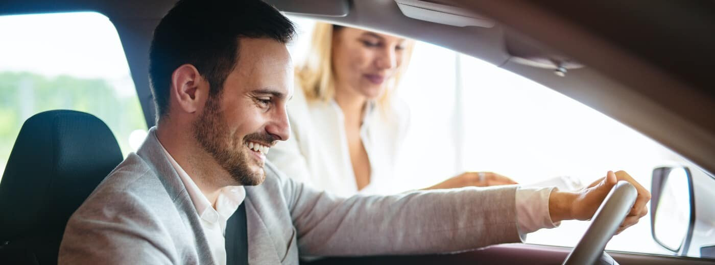 Confident driver evaluating a pre-owned car, with the knowledge gained from Get Drivers Ed.