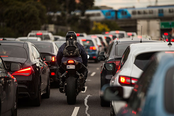 Drivers, cyclists, and pedestrians sharing a busy road in San Antonio, Texas.