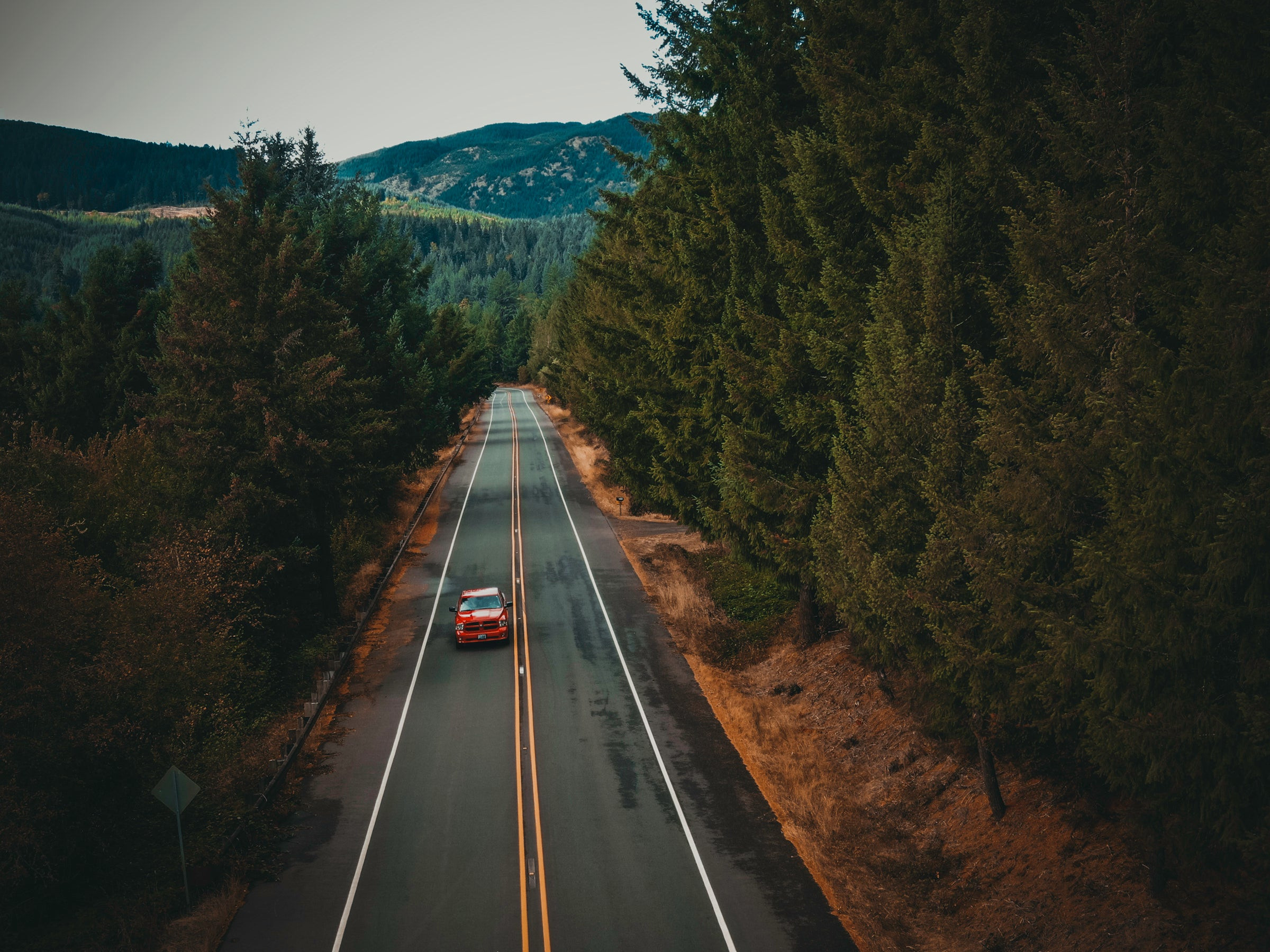 Image of a car driving on a road under different weather conditions, representing mastering various driving conditions with online courses.