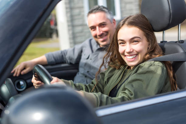 "Parent helping teen study for online drivers ed on a laptop"