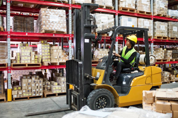 A female forklift operator working confidently in a warehouse, highlighting the rise of women in forklift jobs.