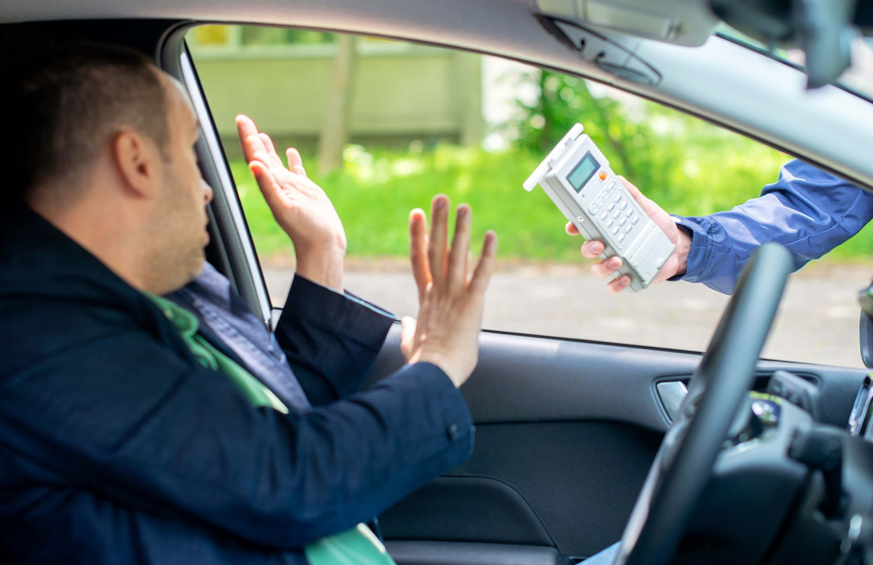 Law enforcement officer conducting a breathalyzer test on a driver during a traffic stop, demonstrating the Implied Consent Law in action.