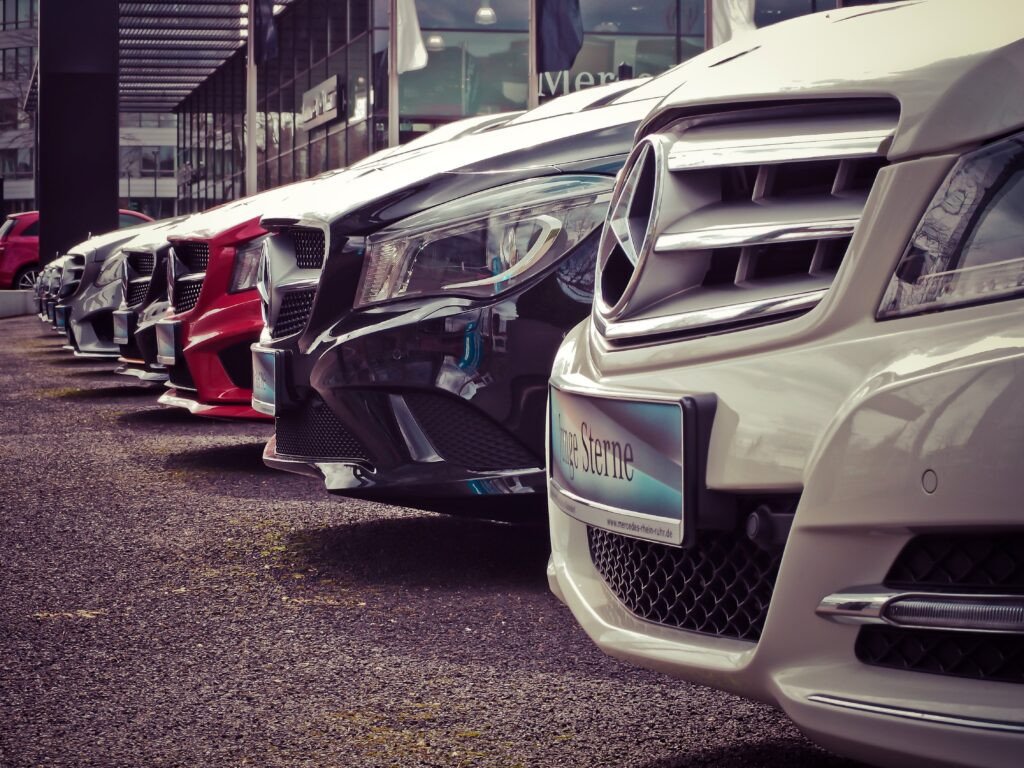 Car maintenance tools next to a car, highlighting the hidden expenses of car ownership.