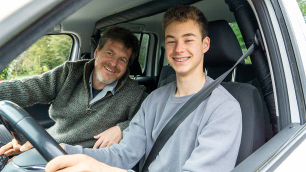 Teen learning to drive with instructor