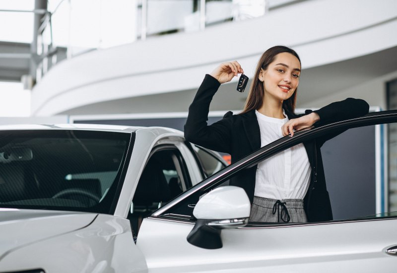 Teen driver standing next to a car chosen for safety and reliability with guidance from Get Drivers Ed