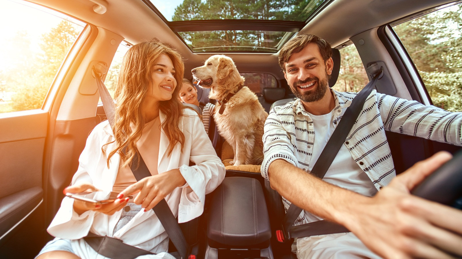 A family traveling with kids and pets in a car, following safety tips from GET DRIVERS ED.