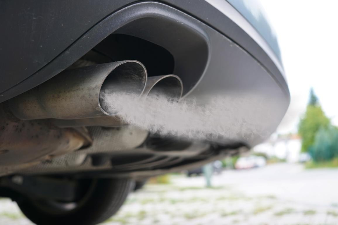 Environmentally conscious driver checking emissions as part of responsible car ownership, educated by Get Drivers Ed.