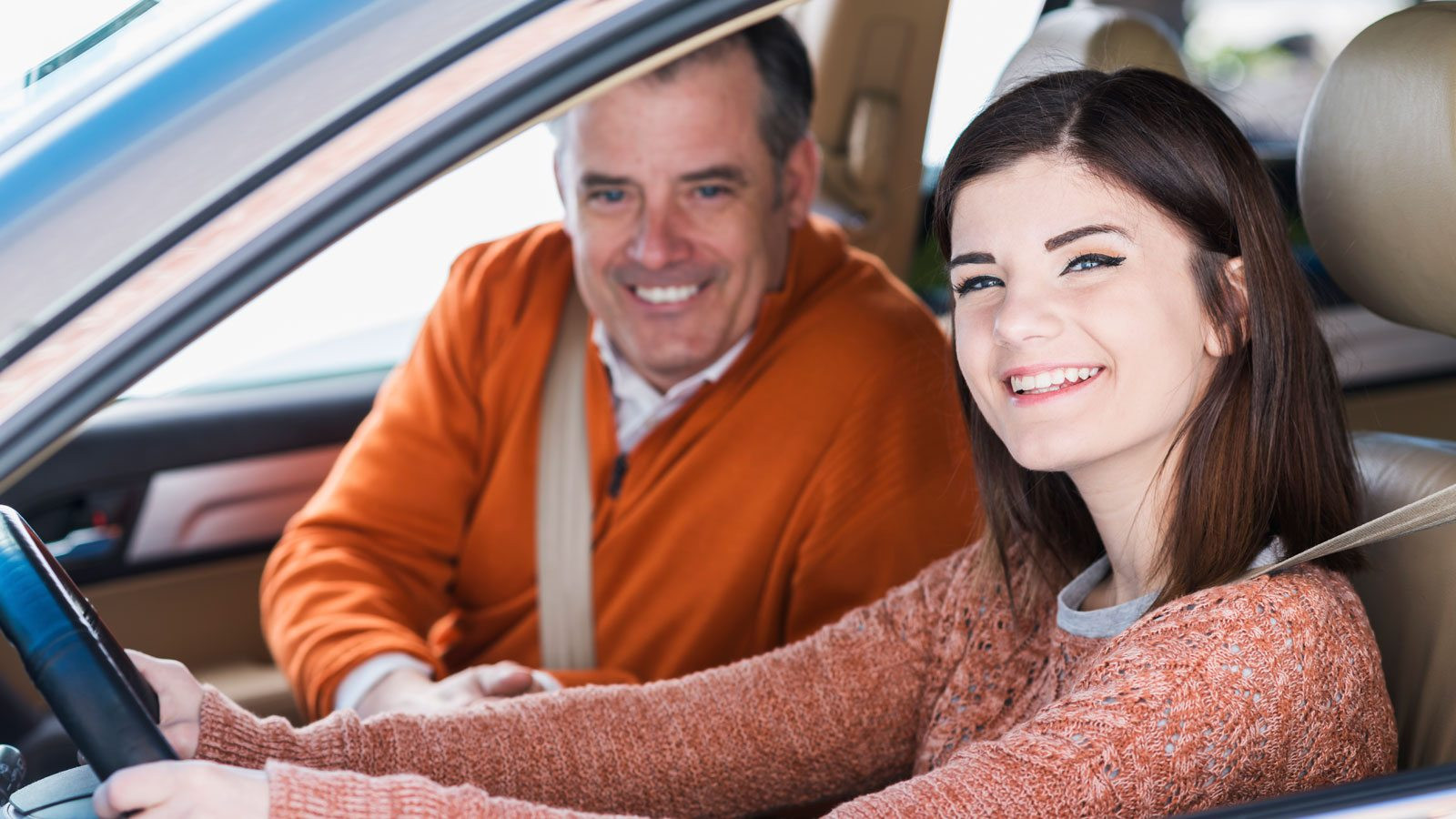 A teen driver learning proper driving techniques during a session at Get Drivers Ed, demonstrating careful steering and observation.