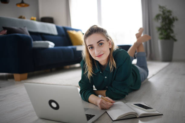 "Online drivers ed student studying on a laptop with driving simulation graphics"