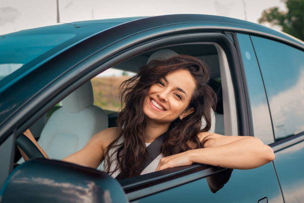 A driver drinking water and eating healthy snacks, highlighting the importance of nutrition and hydration for safe driving.