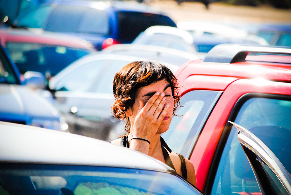 Driver using a smartphone to listen to music during heavy traffic.