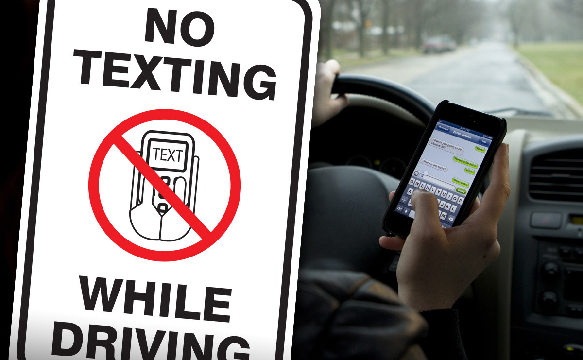 Smartphone on car dashboard displaying a warning message to stop texting while driving, symbolizing Get Drivers Ed's commitment to road safety.