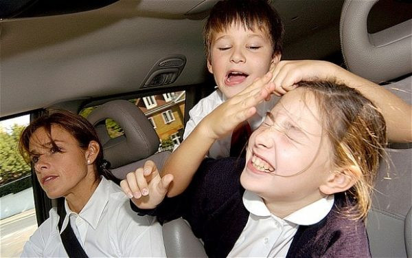 A calm driver handling a passenger distraction while on the road.