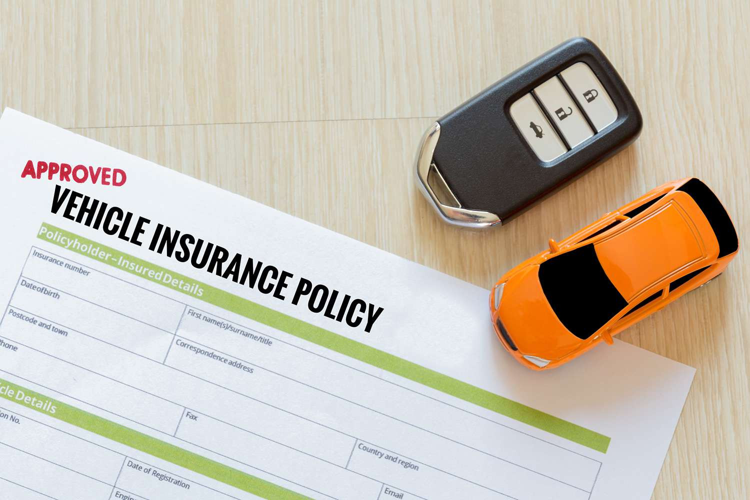 A person checking an insurance policy document next to a car, highlighting the importance of maintaining continuous auto insurance coverage.