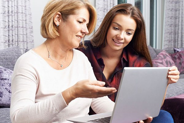 Teen and Parent Studying Together With Get Drivers Ed Online Course on Laptop in Texas