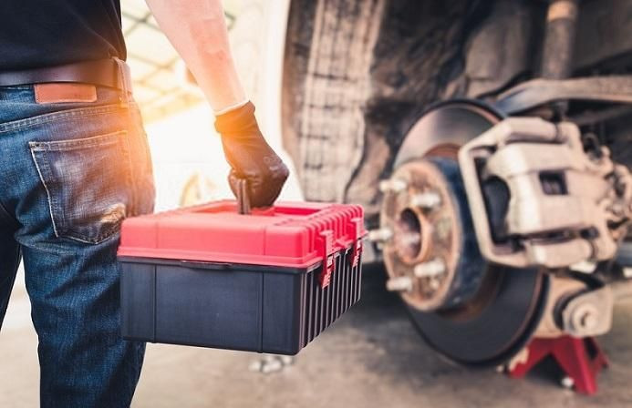 Driver checking car engine oil, learning maintenance tips from Get Drivers Ed