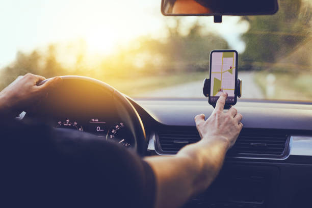 Smartphone displaying a navigation app in a car, essential tools for road trips and commuting