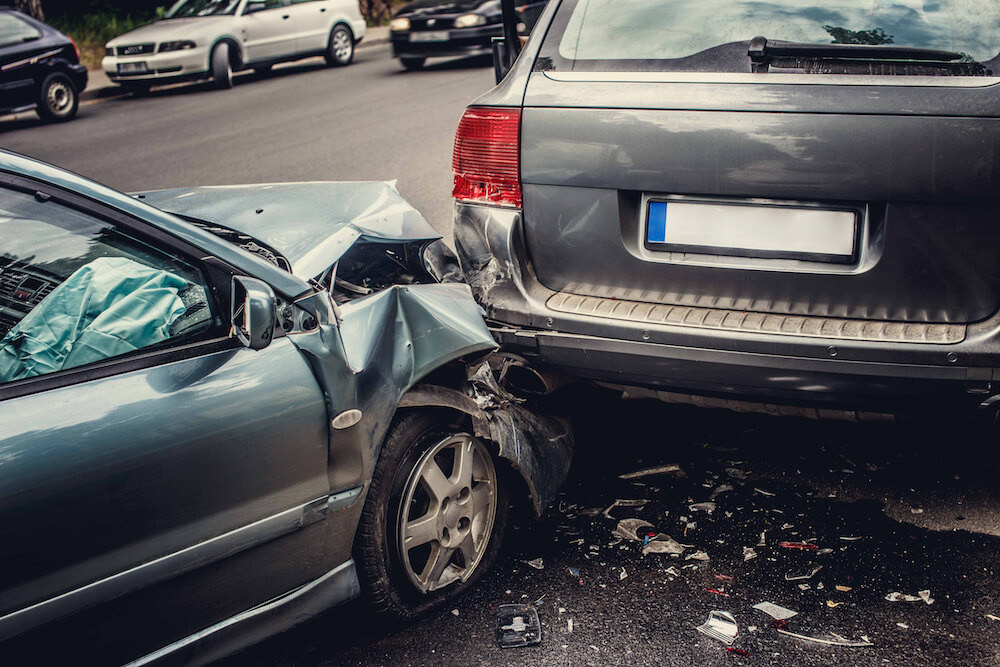 Car accident on the road with two damaged vehicles, highlighting the importance of collision auto insurance