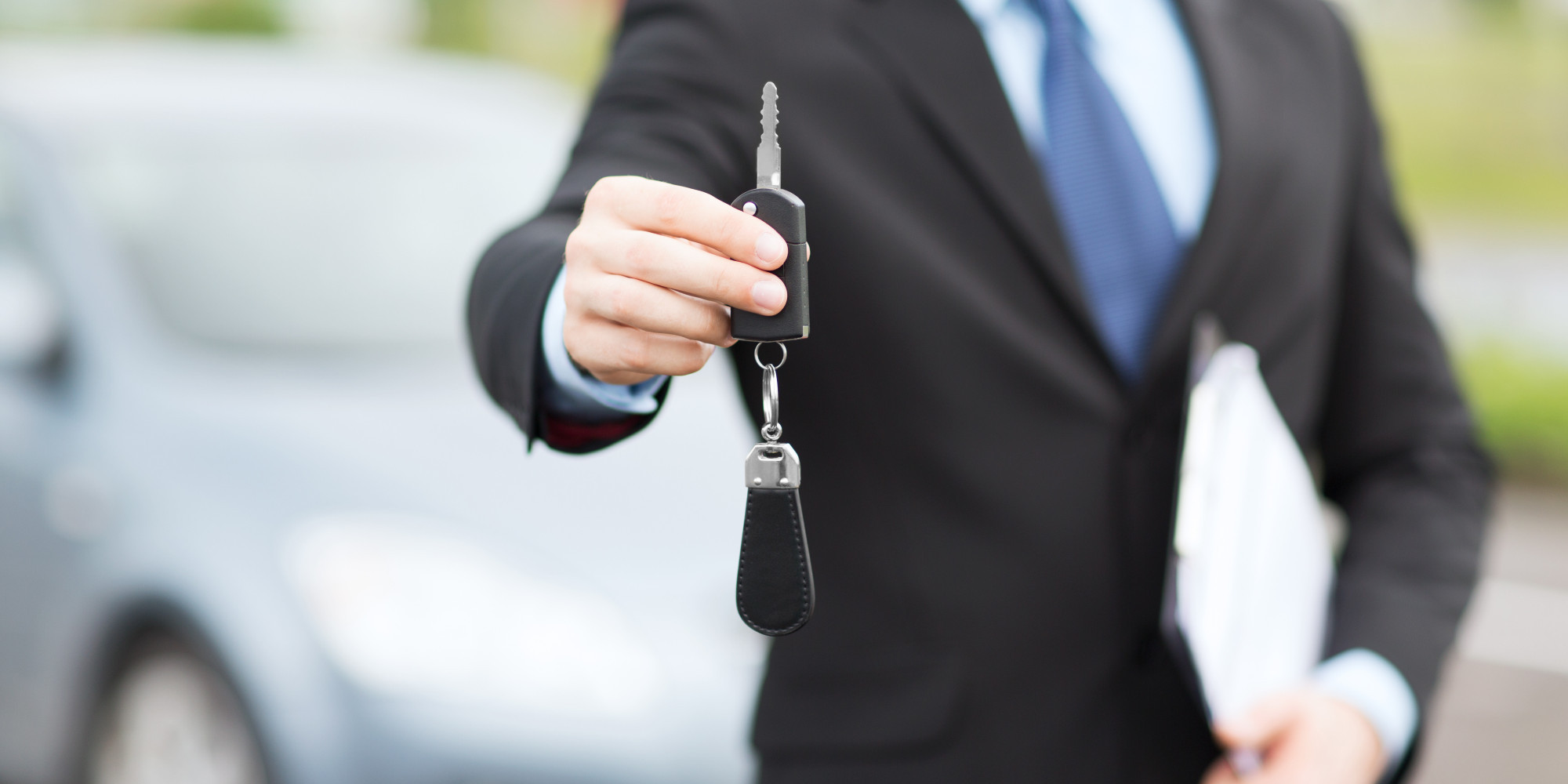 Sales Person Having Car keys in His Hand