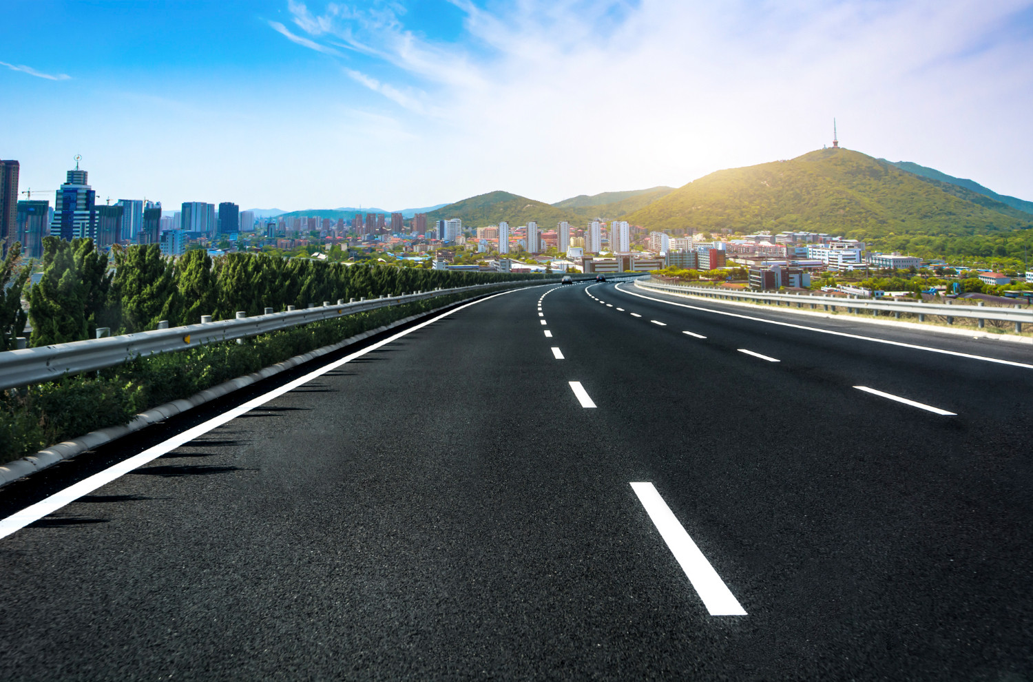 open road with a sleek car cruising down