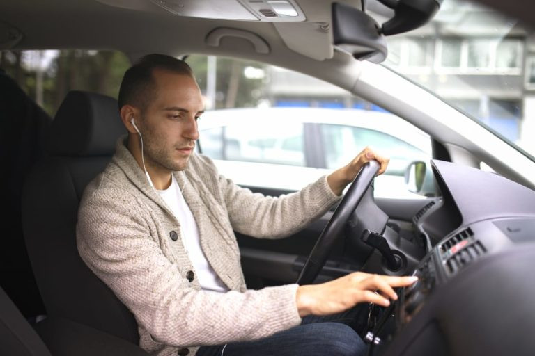 Driver Choosing Safety Over Headphones with Get Drivers Ed Course on Screen