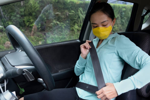 A driver sitting in an upright and comfortable position behind the wheel, ensuring optimal control and safety while driving.