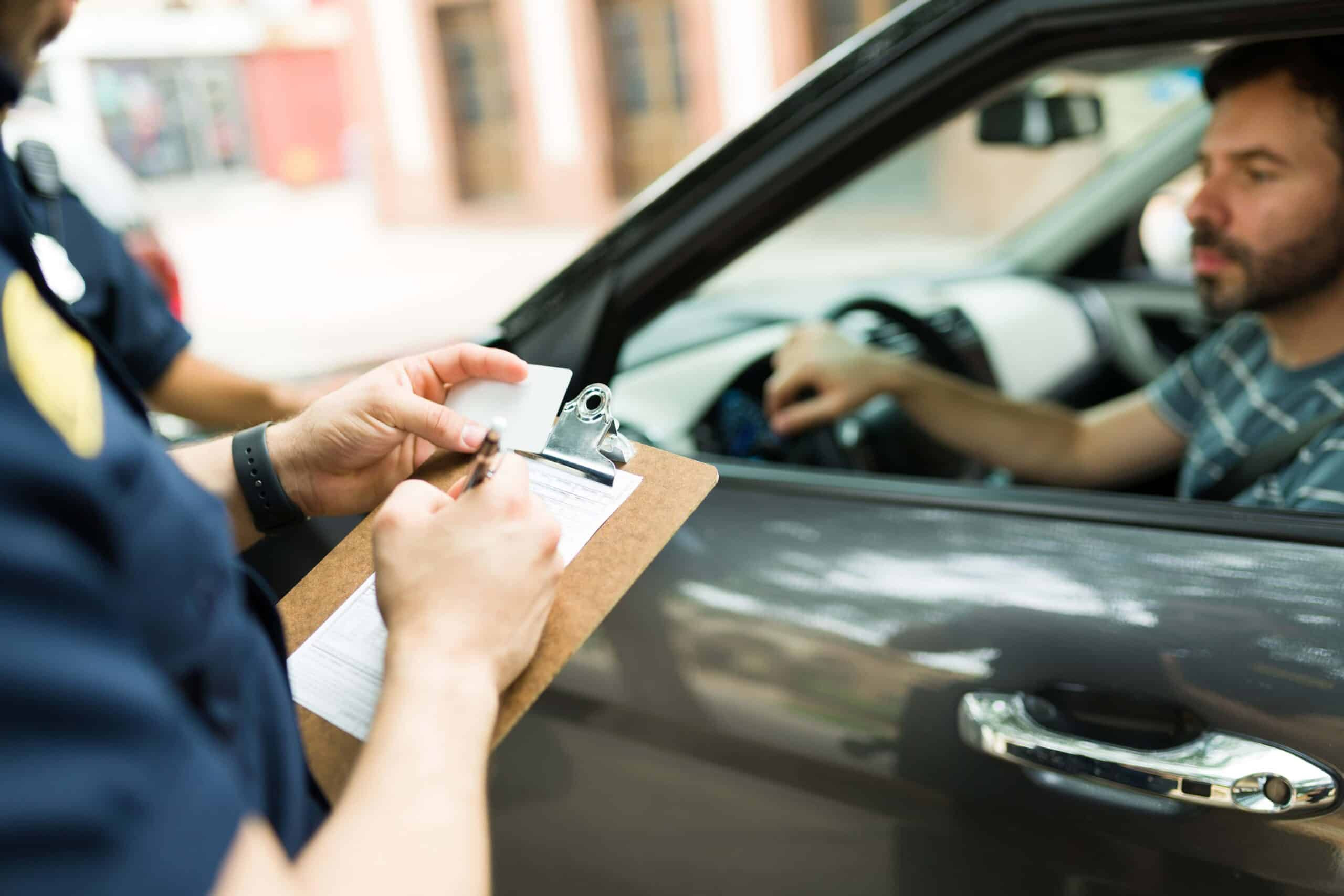 A driver's license with a caution symbol, representing the importance of understanding driver's license points and maintaining a clean driving record.