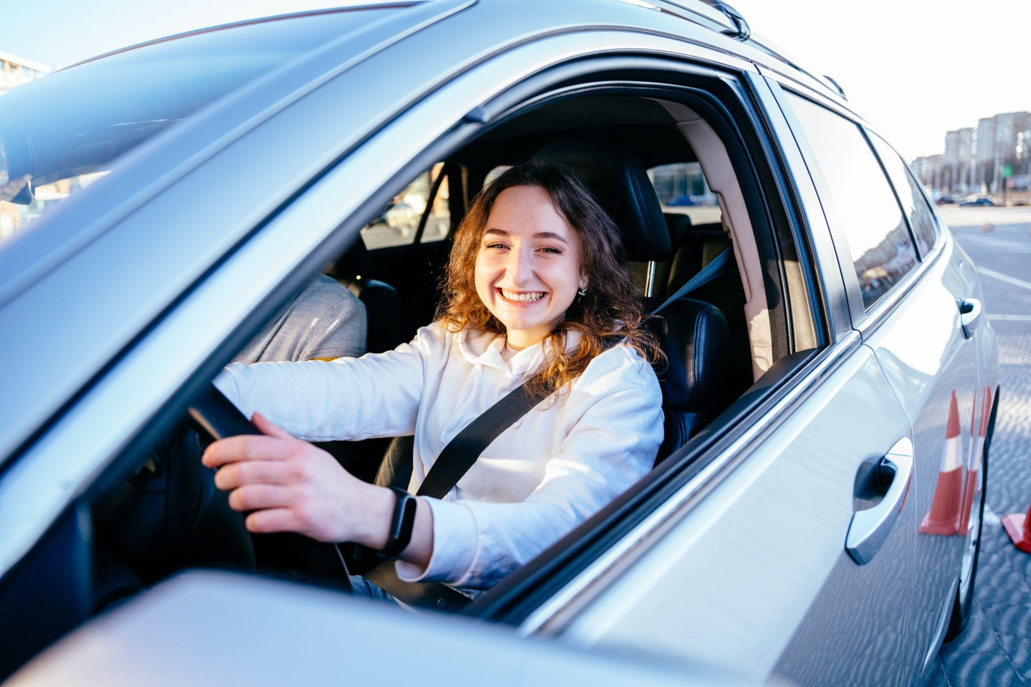 A confident adult learner behind the wheel, practicing safe driving skills on a Texas road after completing an online adult driver education course.