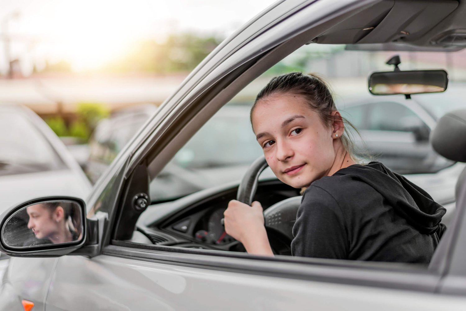 Engaged student learning driving skills from Get Drivers Ed, paving the way for safer driving.