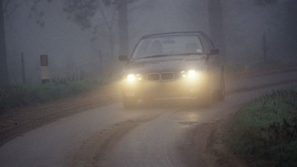 Driver attentively navigating a vehicle through foggy conditions after completing the Get Drivers Ed online course.