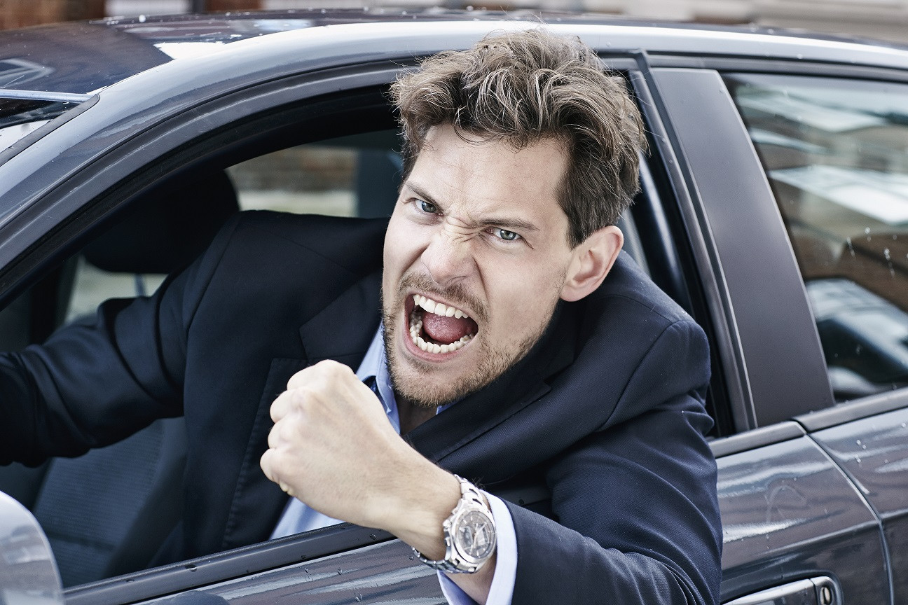 Driver calmly navigating traffic with a smile, showcasing road rage prevention techniques from Get Drivers Ed.