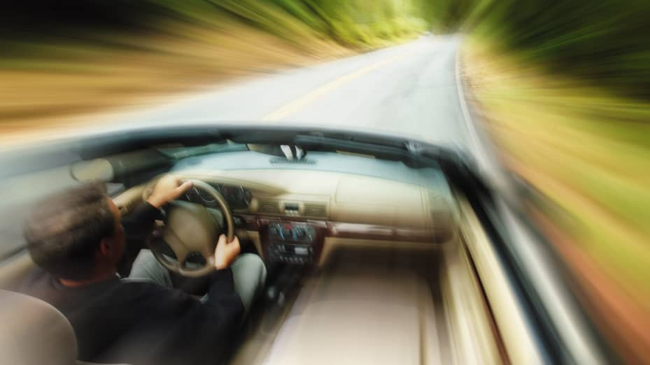 Car speeding on a highway, illustrating the dangers of speeding discussed by Get Drivers Ed