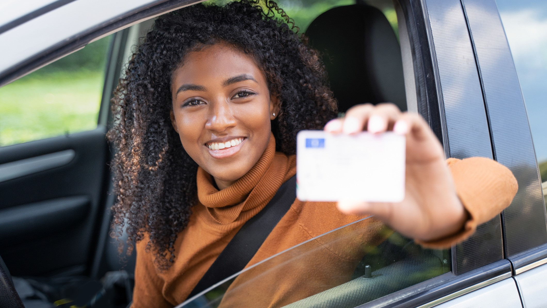 A person reviewing a driver’s license application form with a laptop, symbolizing the process of navigating new driver’s license requirements with GET DRIVERS ED.