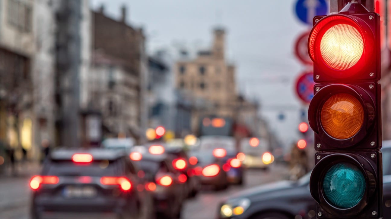 A car approaching an intersection with a red light.