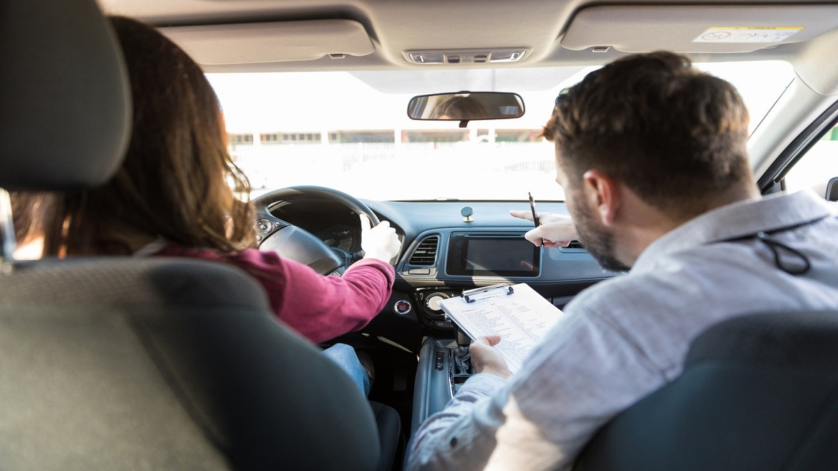 A confident teen driver at the wheel with a parent, symbolizing the success of Get Drivers Ed's parent-taught drivers education program.