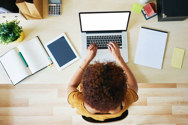 A person sitting comfortably at home, studying for their driver's education course on a laptop, preparing to begin their driving journey with Get Drivers Ed.