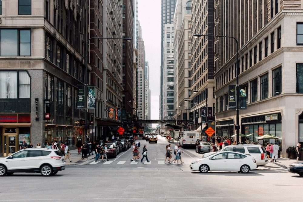 Certified driving instructor giving a lesson to a student driver in a big city environment