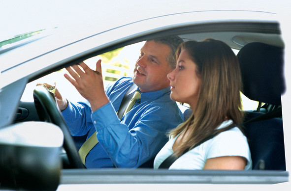 A confident teen driving with a parent beside them, showcasing the success of Texas's parent-taught drivers education course by Get Drivers Ed.