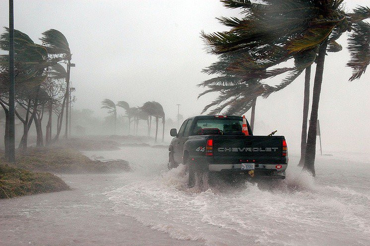 Car driving safely through heavy rain during a hurricane, following tips from Get Drivers Ed