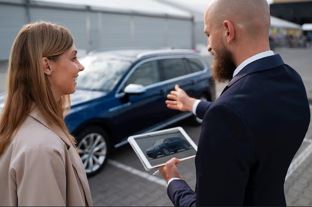 Person taking photos of a car for an online listing, showcasing steps to sell your car online.