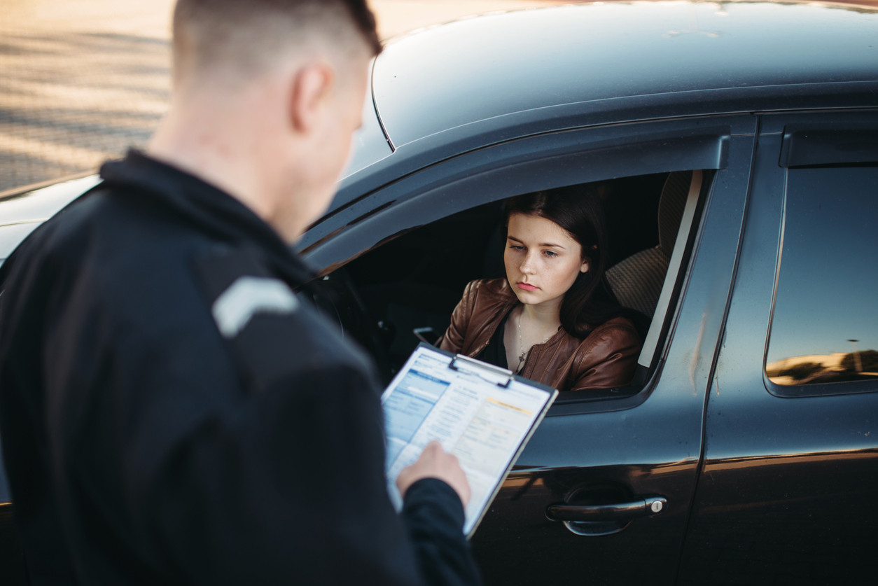 A driver safely navigating a busy road, demonstrating compliance with traffic laws and safe driving practices taught by Get Drivers Ed.