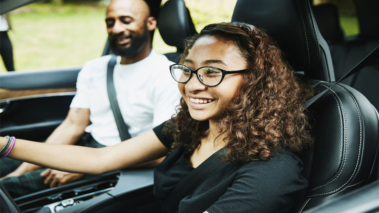 Parent teaching teenager to drive with a focus on safety and skills in Texas