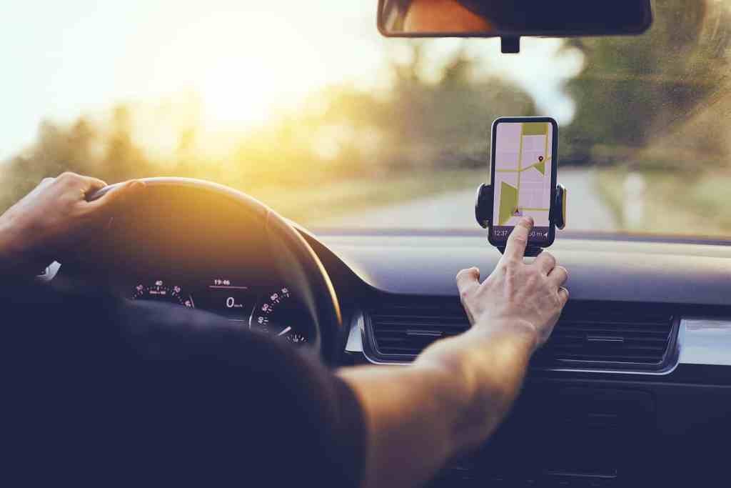 Car Driver Checking Direction Map in Phone