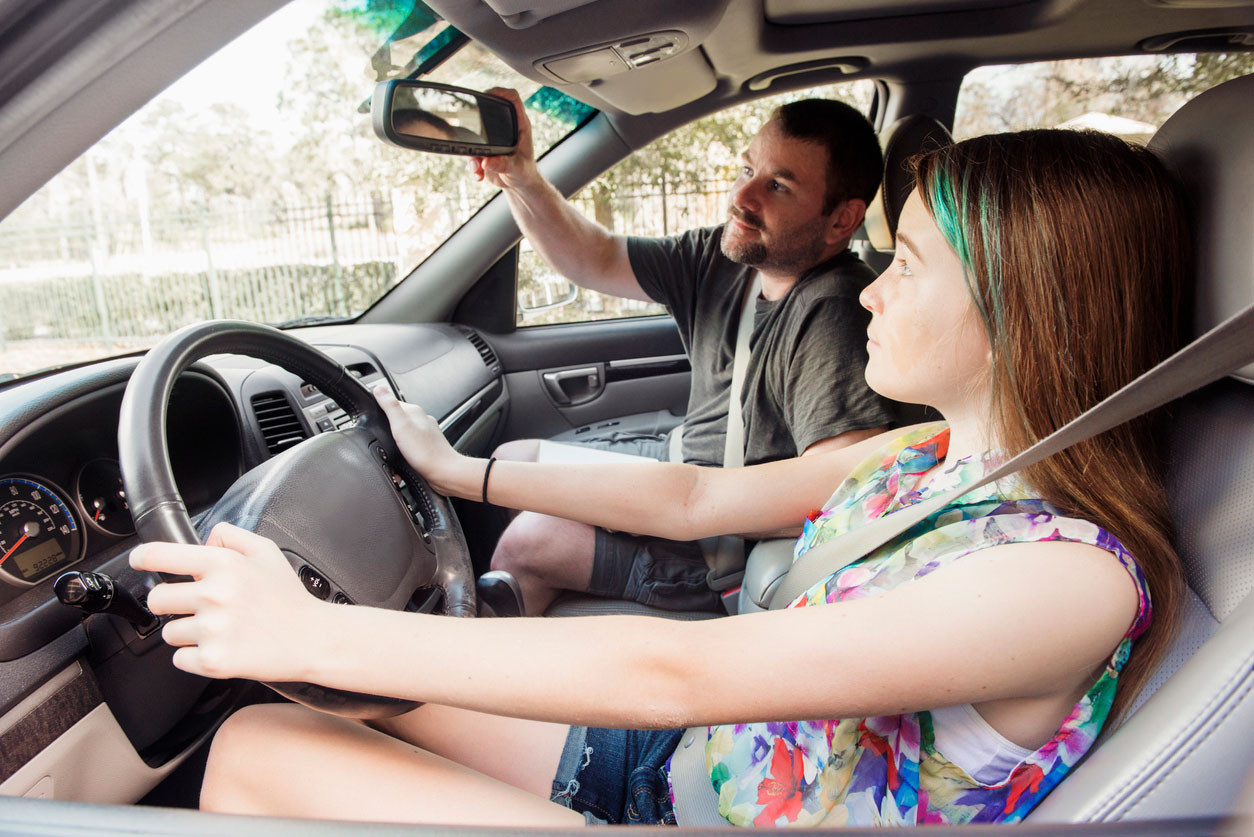 A teenage driver learning safe driving practices with an instructor at Get Drivers Ed.