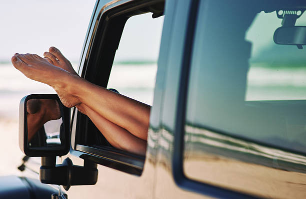 A driver wearing proper footwear, demonstrating safe driving practices.