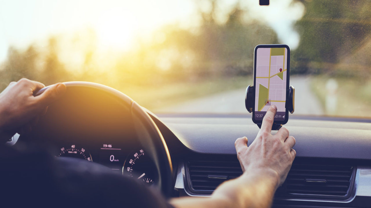 Smartphone screen showing live car tracking, representing modern drivers ed techniques taught at Get Drivers Ed.