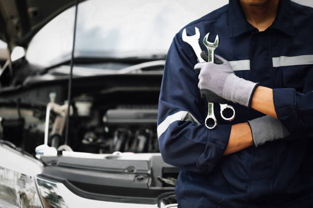 "New driver checking car oil level for maintenance"