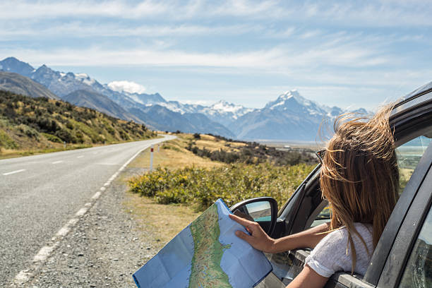 A scenic view of a winding road through the mountains, representing one of the top road trip destinations for new drivers.