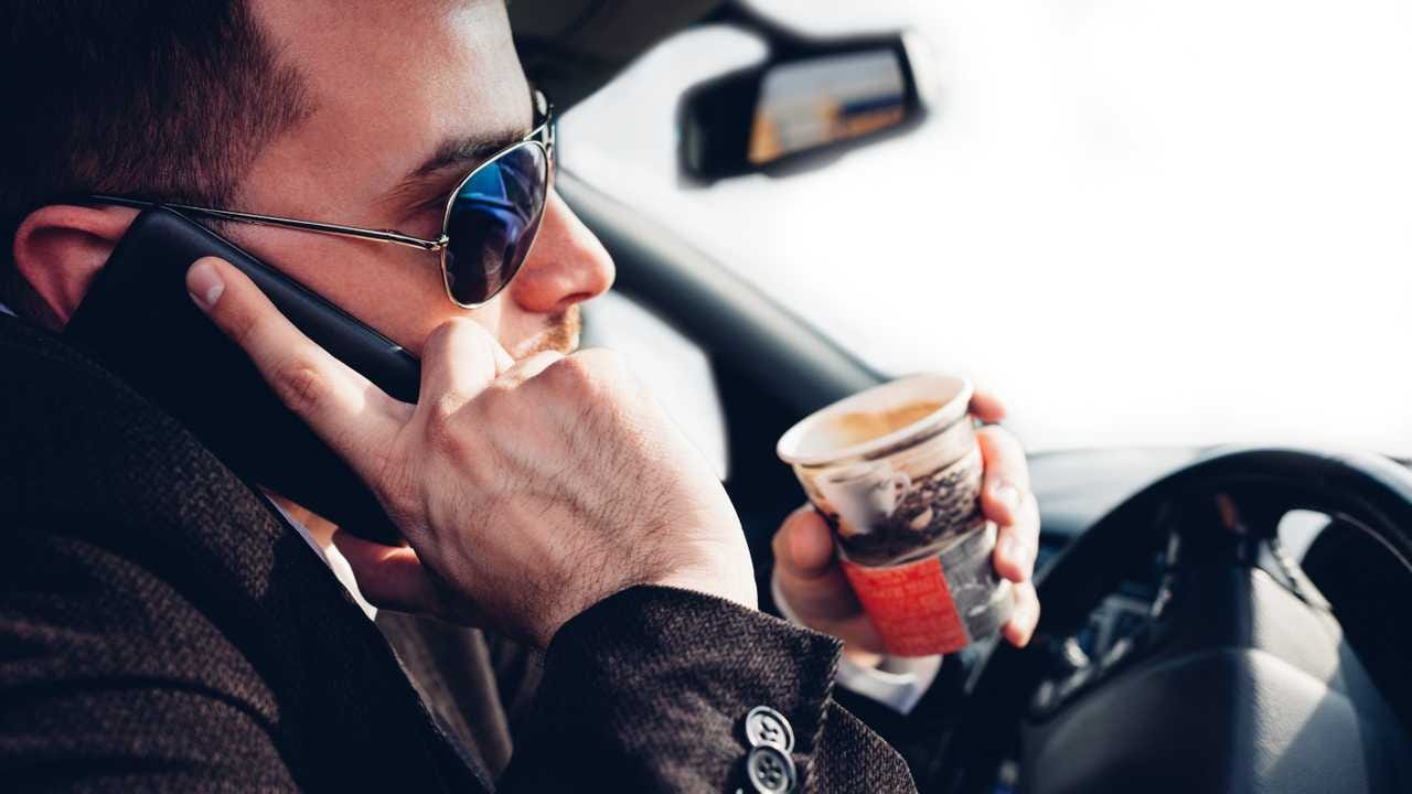 Focused Driver Avoiding Distractions with Get Drivers Ed Course on Dashboard Screen